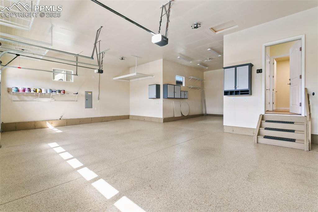Image 36 of 49: 4-car Garage with storage, finished and epoxy flooring