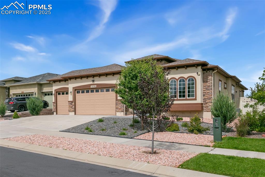 Image 46 of 49: Mediterranean / spanish-style home featuring driveway, stucco siding, stone