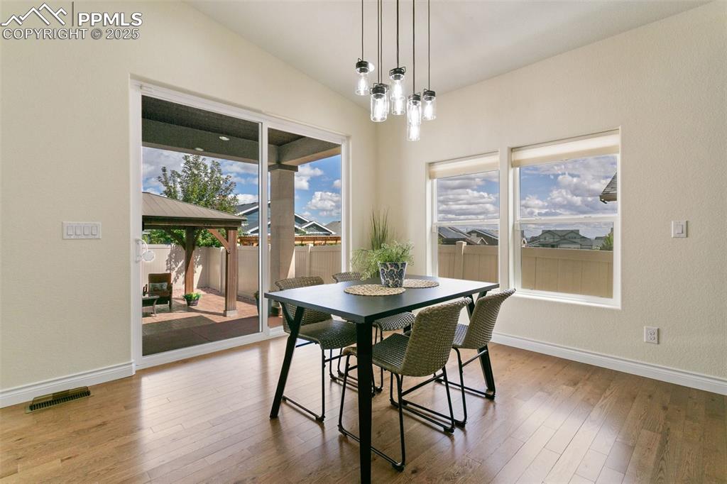 Image 6 of 49: Dining space featuring light wood-style floors and a chandelier