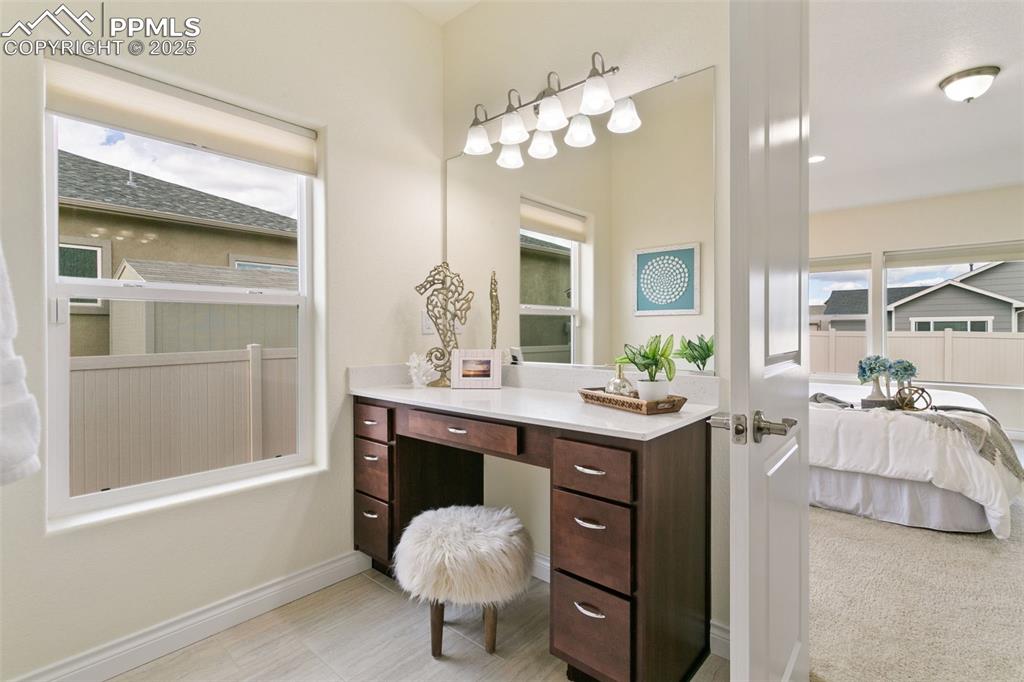 Image 9 of 49: Bathroom featuring plenty of natural light, vanity, and light tile patterne