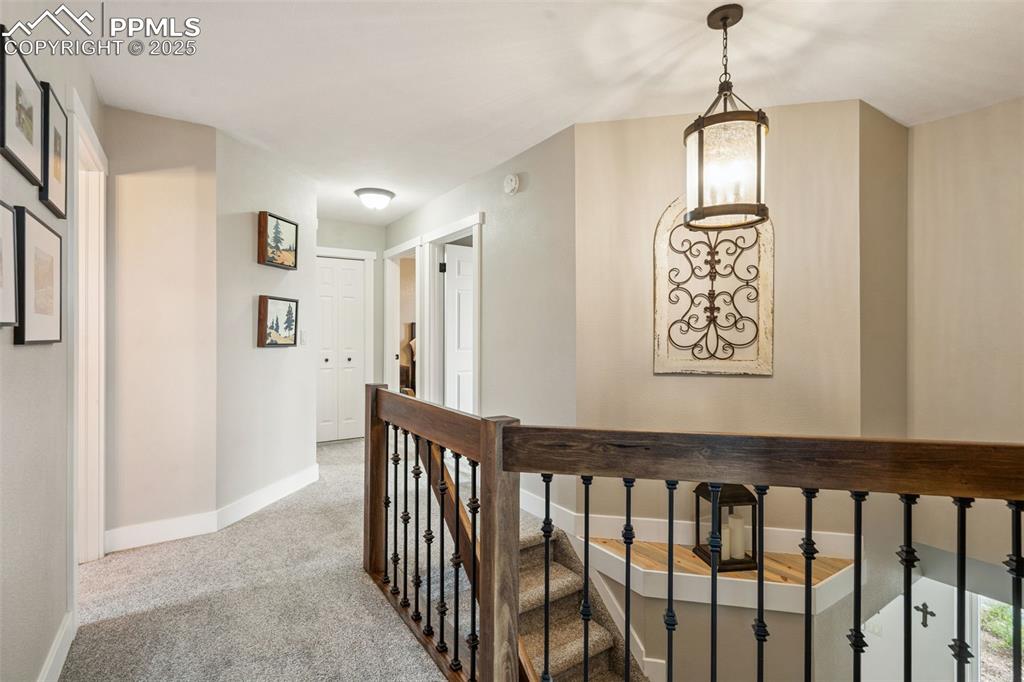Image 29 of 49: Upper level with lovely wrought iron rails