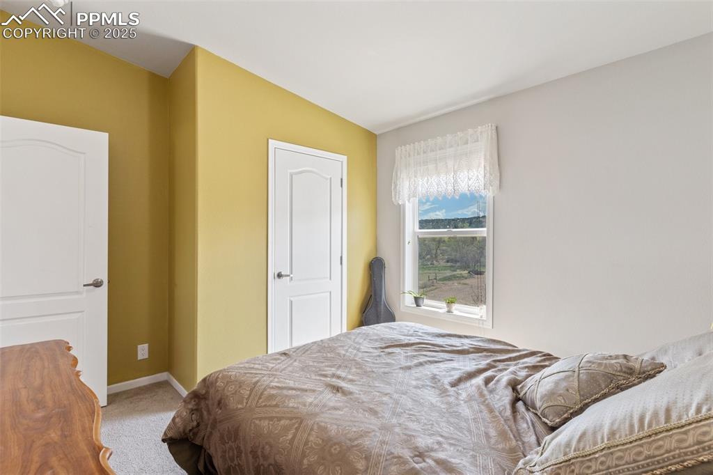 Image 21 of 50: Bedroom featuring carpet and baseboards