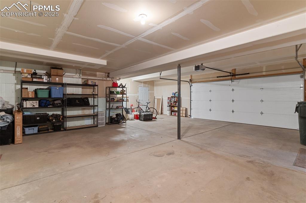 Image 27 of 50: Garage with a garage door opener