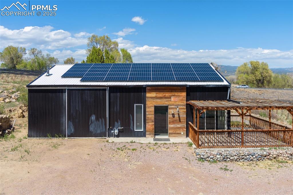 Image 29 of 50: View of front of home featuring roof mounted solar panels and an outdoor st