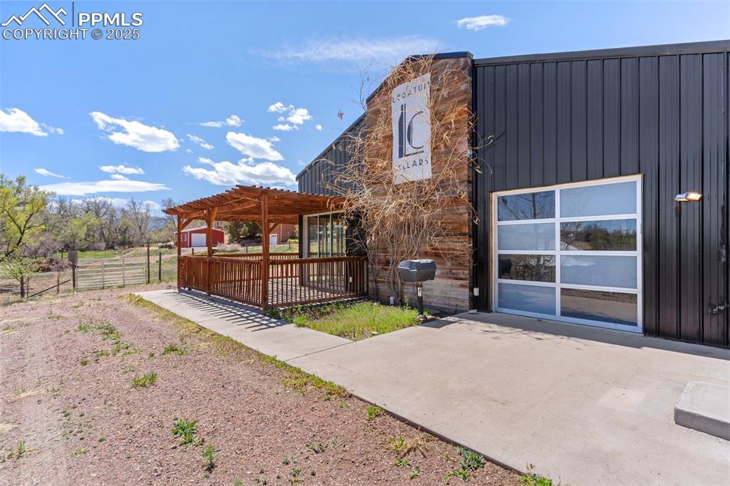 Image 31 of 50: Rear view of property featuring a pergola, fence, and a patio area