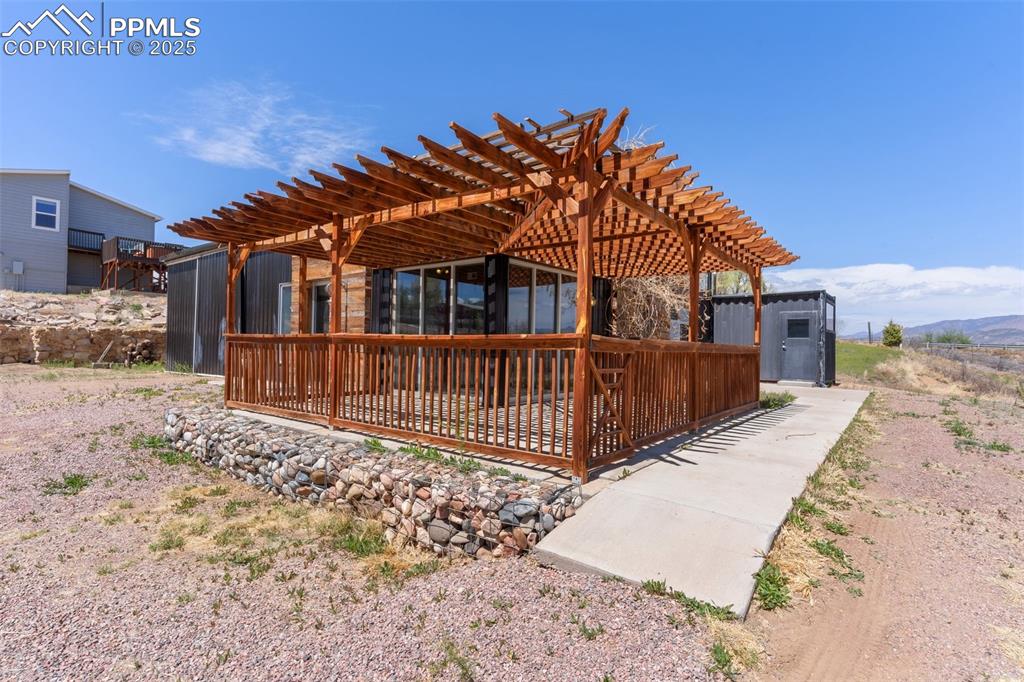 Image 32 of 50: Rear view of property featuring a pergola and a patio