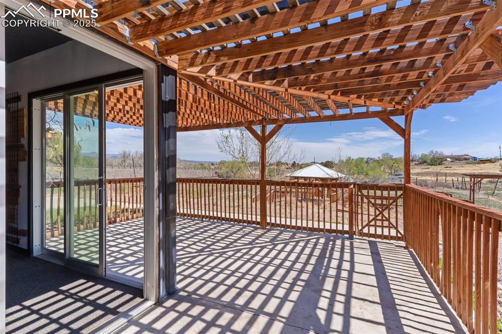 Image 33 of 50: Deck with a pergola and a patio