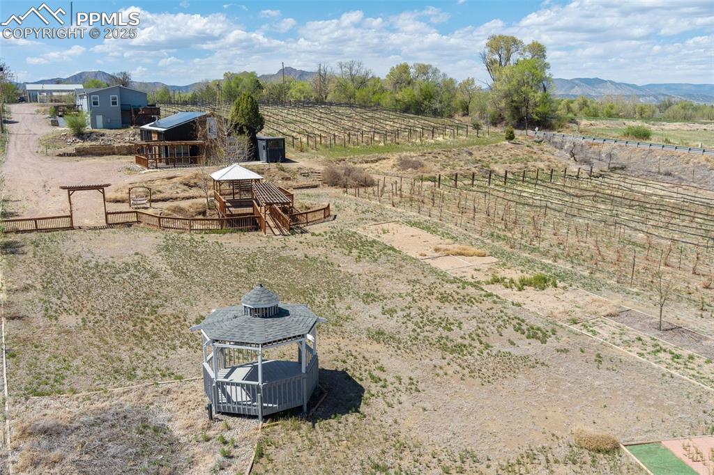 Image 36 of 50: Aerial view featuring a mountain view and a rural view