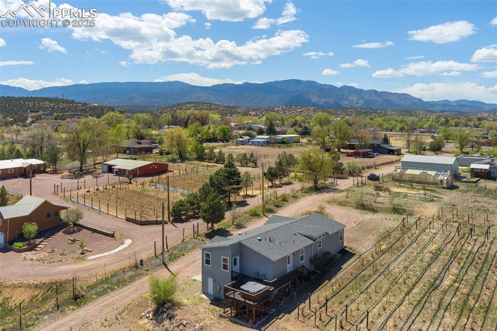 Image 5 of 50: Birds eye view of property with a mountain view and a rural view