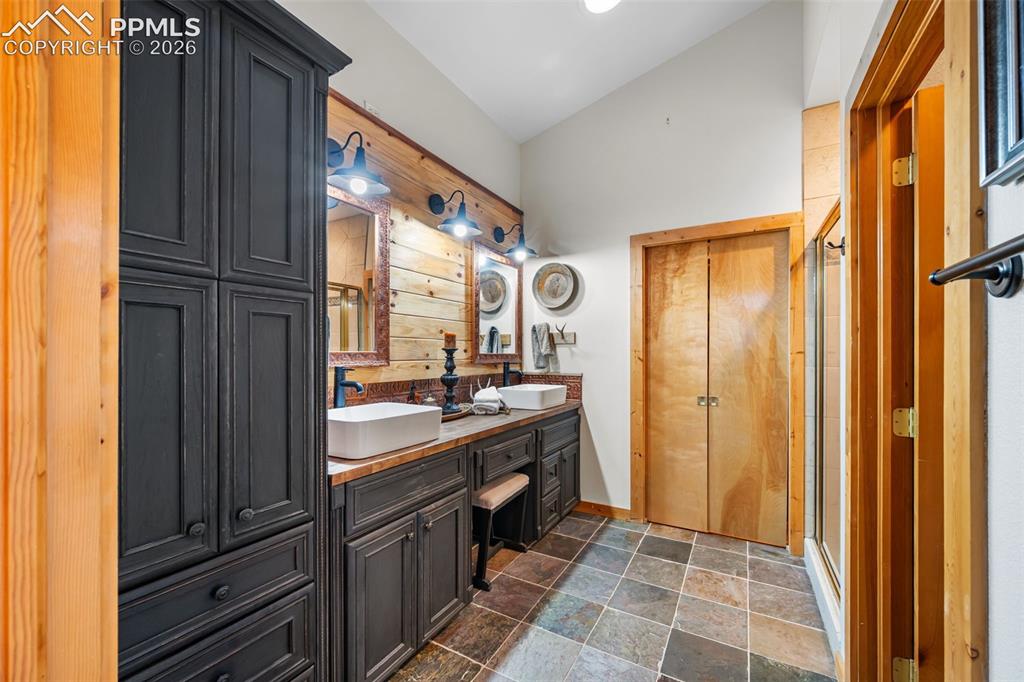 Image 12 of 34: Designed for comfort, the primary suite bathroom features dual vanities, wa
