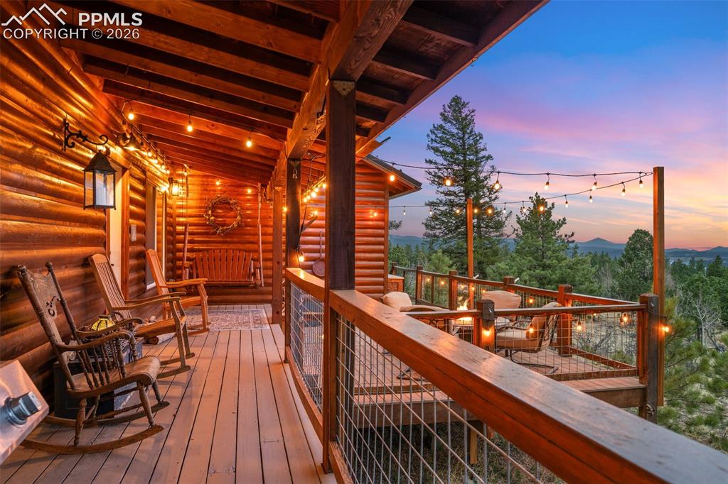 Image 18 of 34: Perfect for relaxing or entertaining, the covered deck features warm wood f