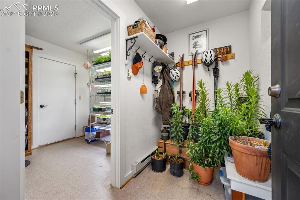 Image 26 of 34: Functional transition space to the garage, offering convenient storage and