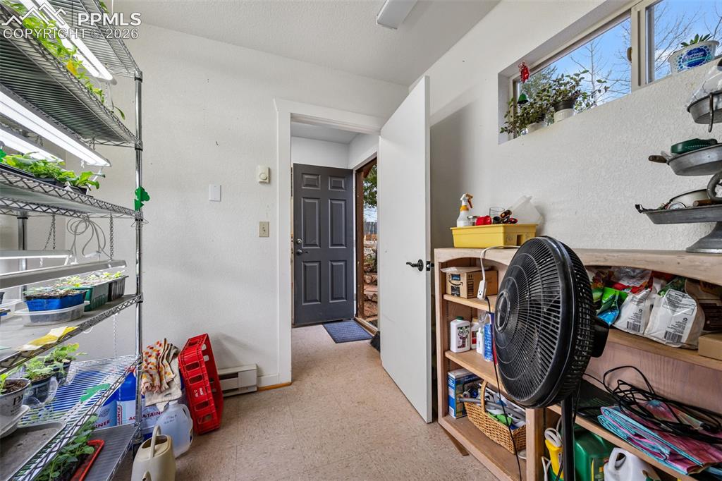 Image 27 of 34: Practical mudroom style space leading to the garage, with ample storage and
