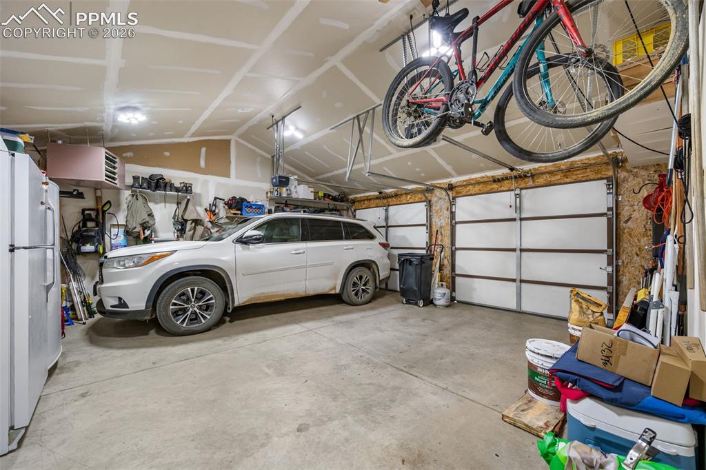 Image 28 of 34: Spacious and functional, the heated garage offers ample room for vehicles,