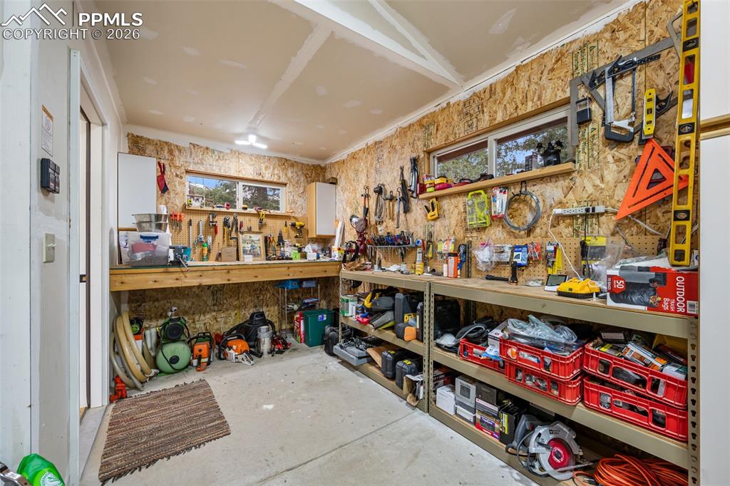 Image 29 of 34: Dedicated workshop space, well equipped with ample workspace, storage, and