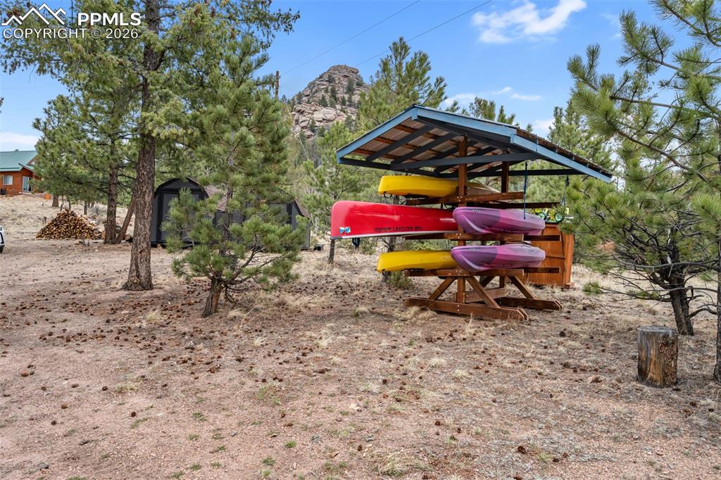 Image 31 of 34: Covered storage area provides convenient space for outdoor gear, with a sce