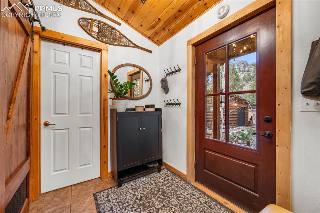 Image 4 of 34: Warm and welcoming, the entryway features rustic wood accents, thoughtful d