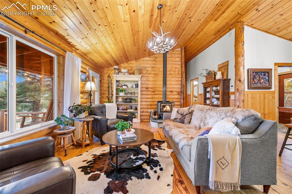 Image 7 of 34: Warm and inviting, the living room features soaring wood ceilings, a cozy w