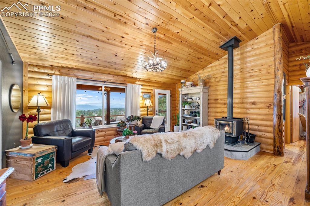 Image 8 of 34: Bright and welcoming, this living space showcases warm wood finishes, a coz