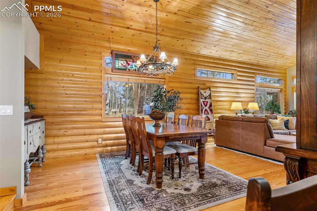 Image 9 of 34: Surrounded by rich wood finishes and natural light, the dining area offers