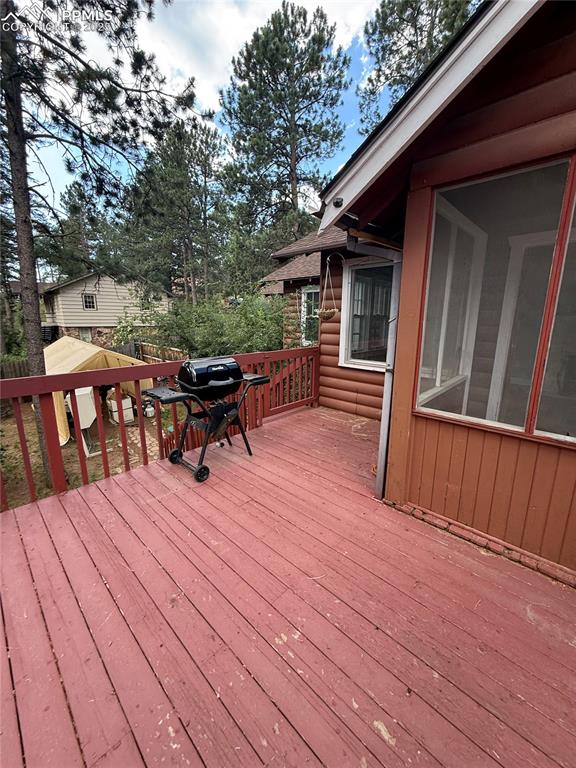 Image 13 of 23: Wooden terrace featuring grilling area
