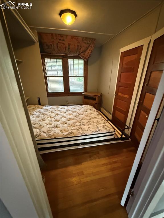 Image 6 of 23: Bedroom featuring wood finished floors