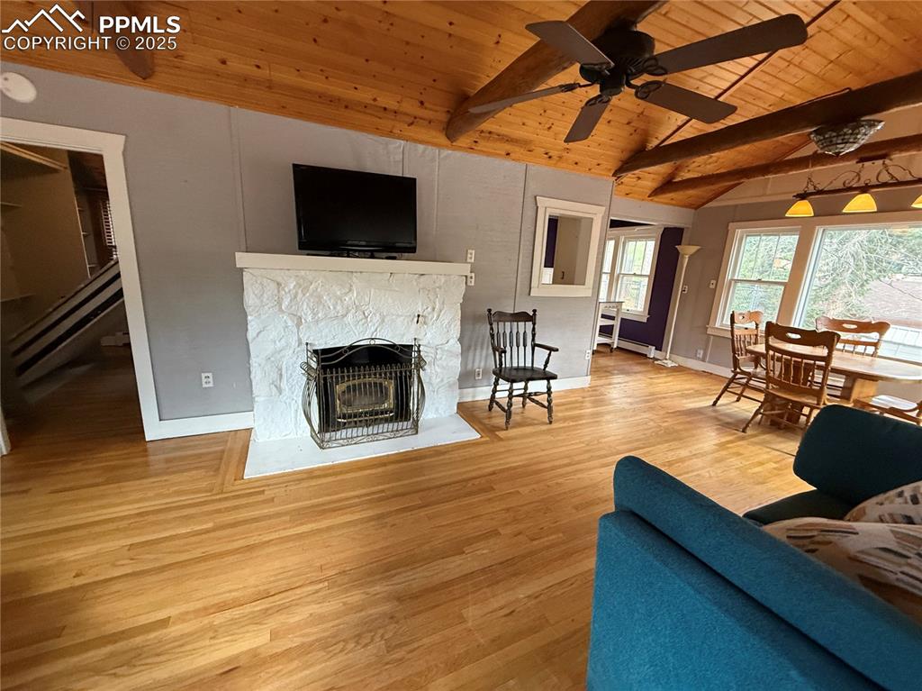 Image 9 of 23: Living room featuring wooden ceiling, wood finished floors, ceiling fan, a