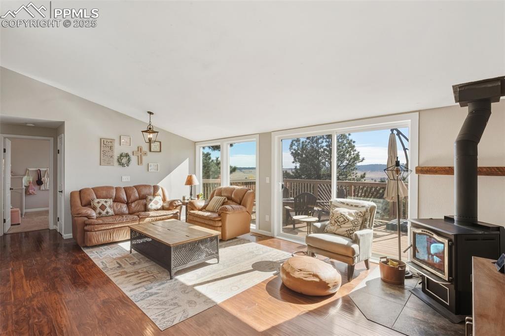 Image 12 of 33: Great room featuring amazing views and wood burning stove