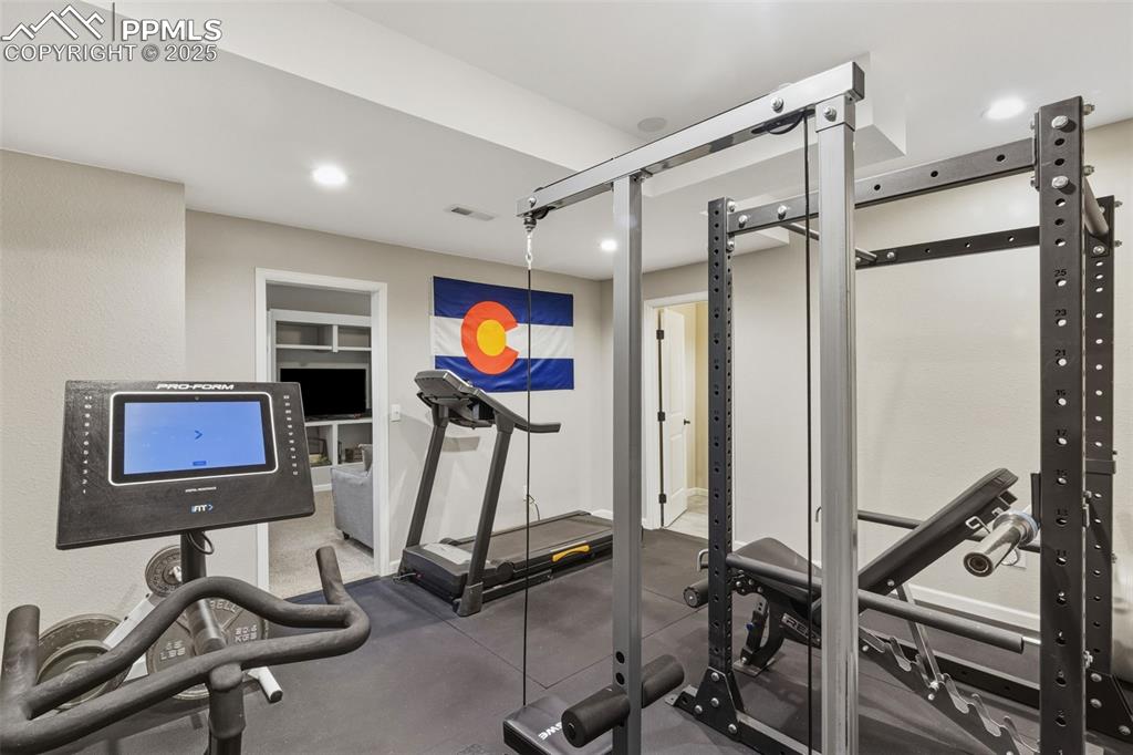 Image 23 of 33: Workout room featuring recessed lighting and rubber floors