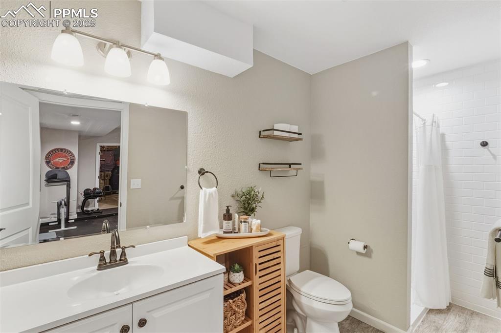 Image 24 of 33: 3/4 bath adjacent to dedicated gym area