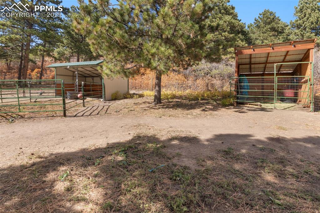 Image 27 of 33: View of run-in shed and hay/misc storage