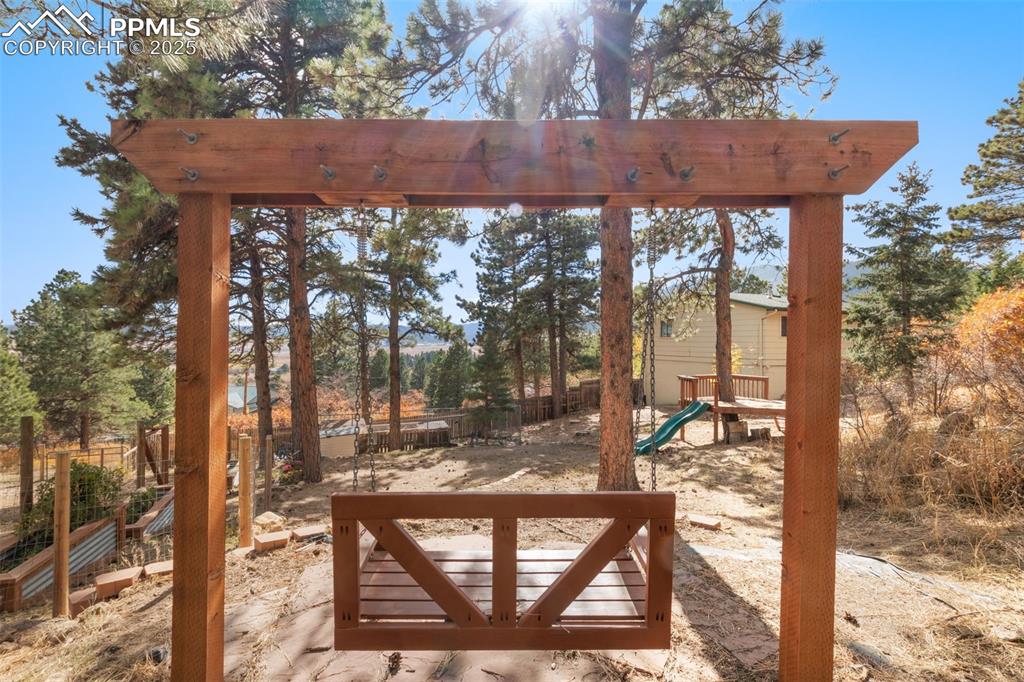 Image 30 of 33: Wooden swing facing mountain views