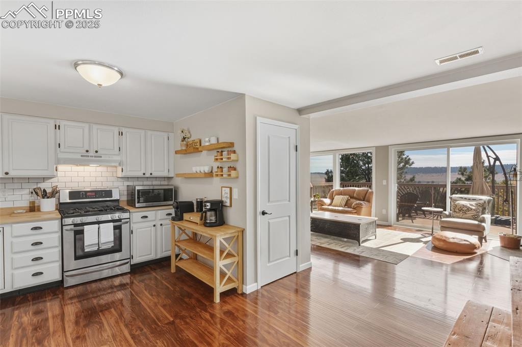 Image 9 of 33: Kitchen and view to the great room