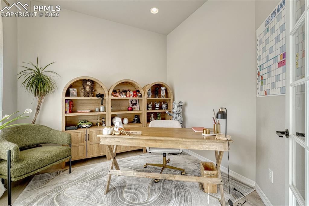 Image 23 of 50: Office has glass doors for privacy