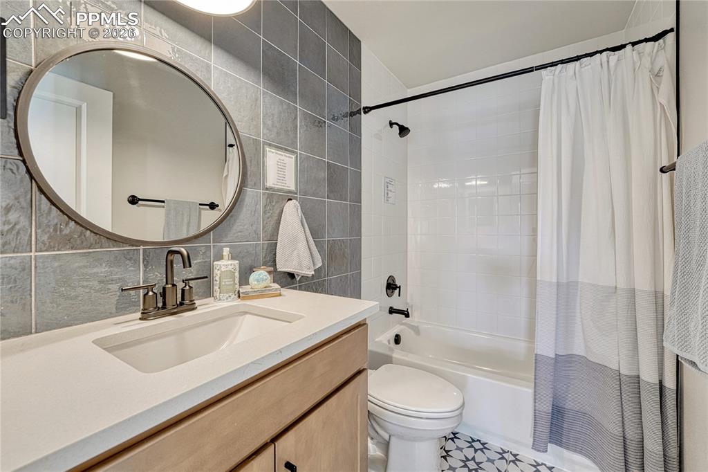 Image 24 of 50: Main level 2nd bath, designer tile