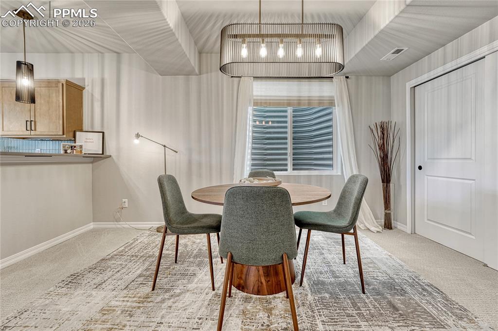 Image 28 of 50: Basement has a wet bar and dining area, could be game area