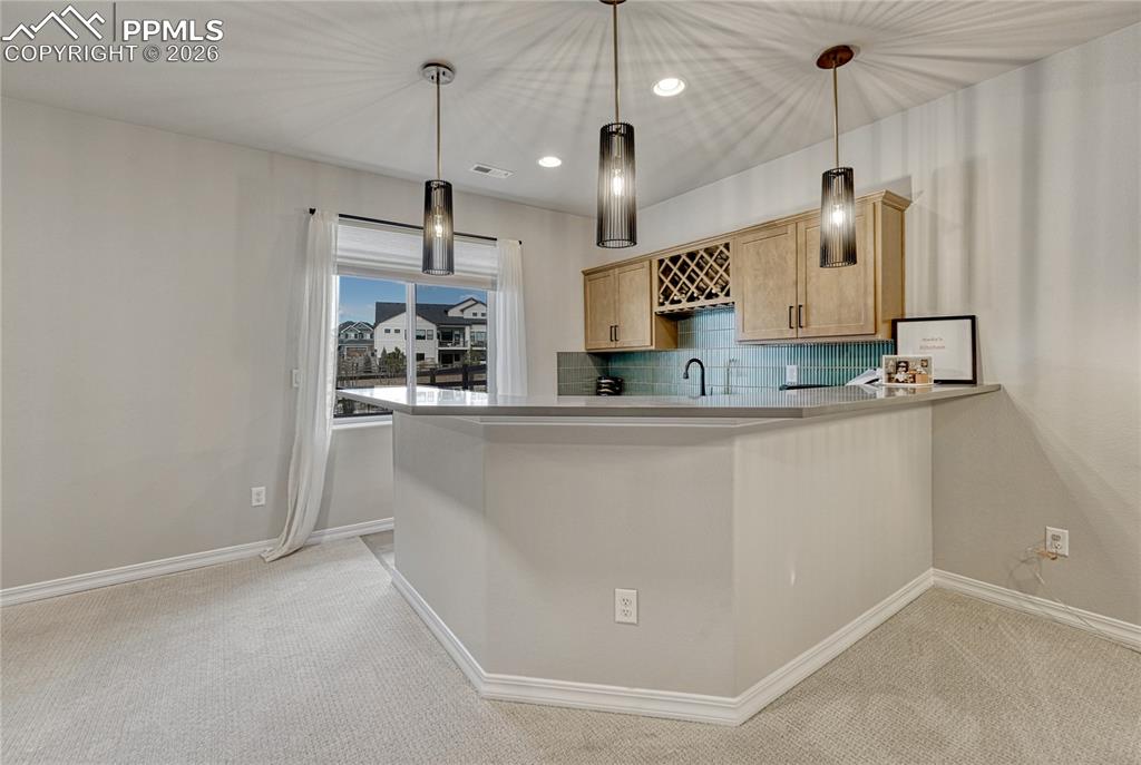 Image 30 of 50: Wet bar/mini kitchen in basement