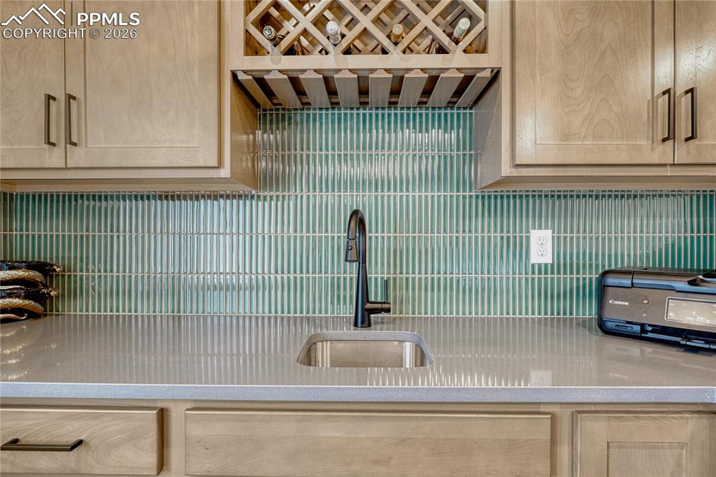 Image 32 of 50: Gorgeous tile and wine rack