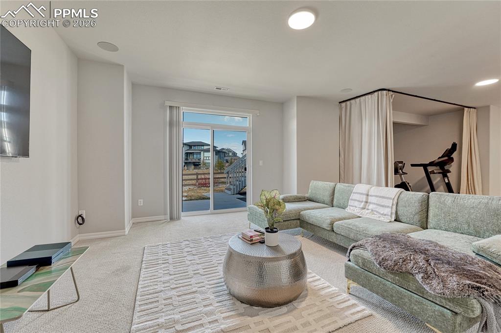 Image 34 of 50: Family room space with walkout in the basement