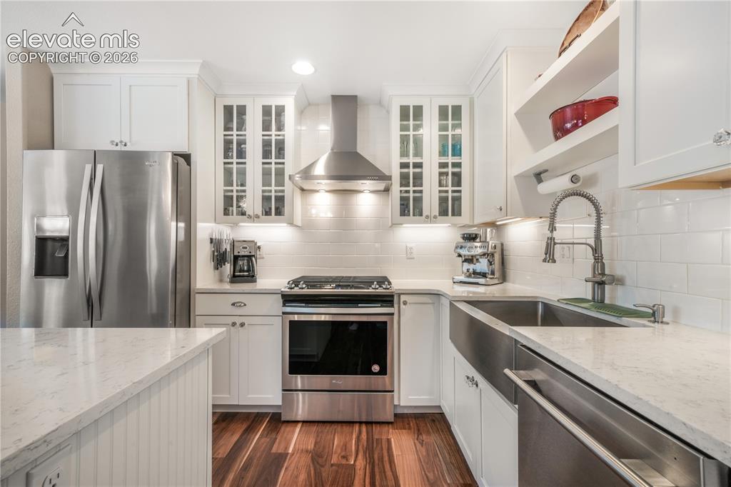 Image 14 of 50: Dining room with access from front of home and around to kitchen and breakf