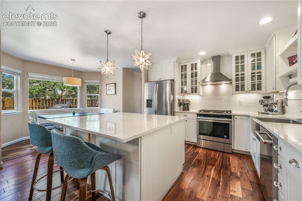 Image 15 of 50: Dining room with access from front of home and around to kitchen and breakf