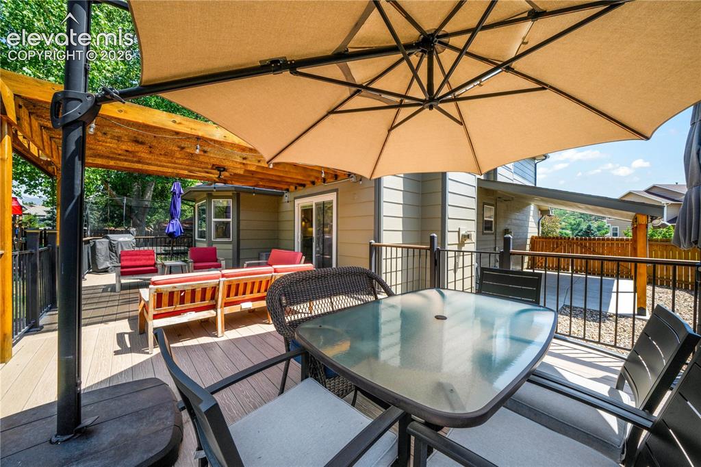 Image 22 of 50: Family room with gas fireplace and walk out access to the decks and backyar