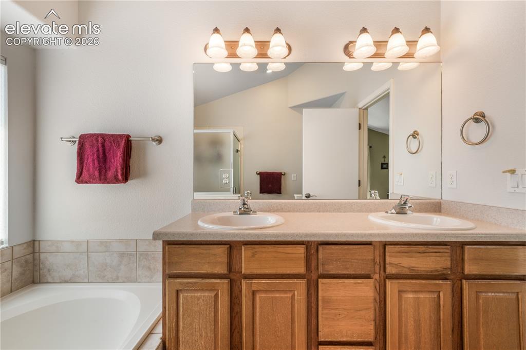 Image 29 of 50: Upstairs primary bedroom with large seating area, walk in closet and 5 piec