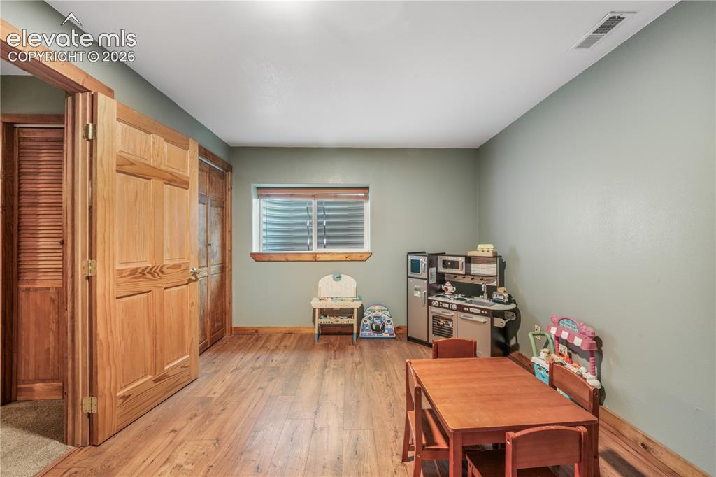 Image 40 of 50: Basement family room, built in entertainment area, electric fireplace inser