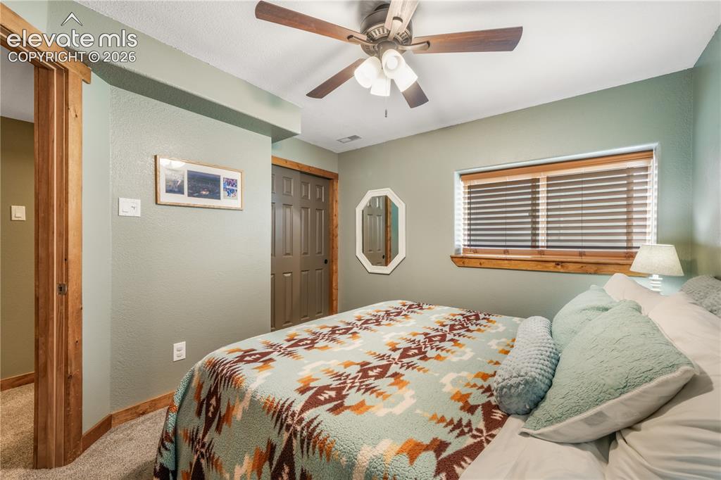 Image 42 of 50: Basement family room, built in entertainment area, electric fireplace inser