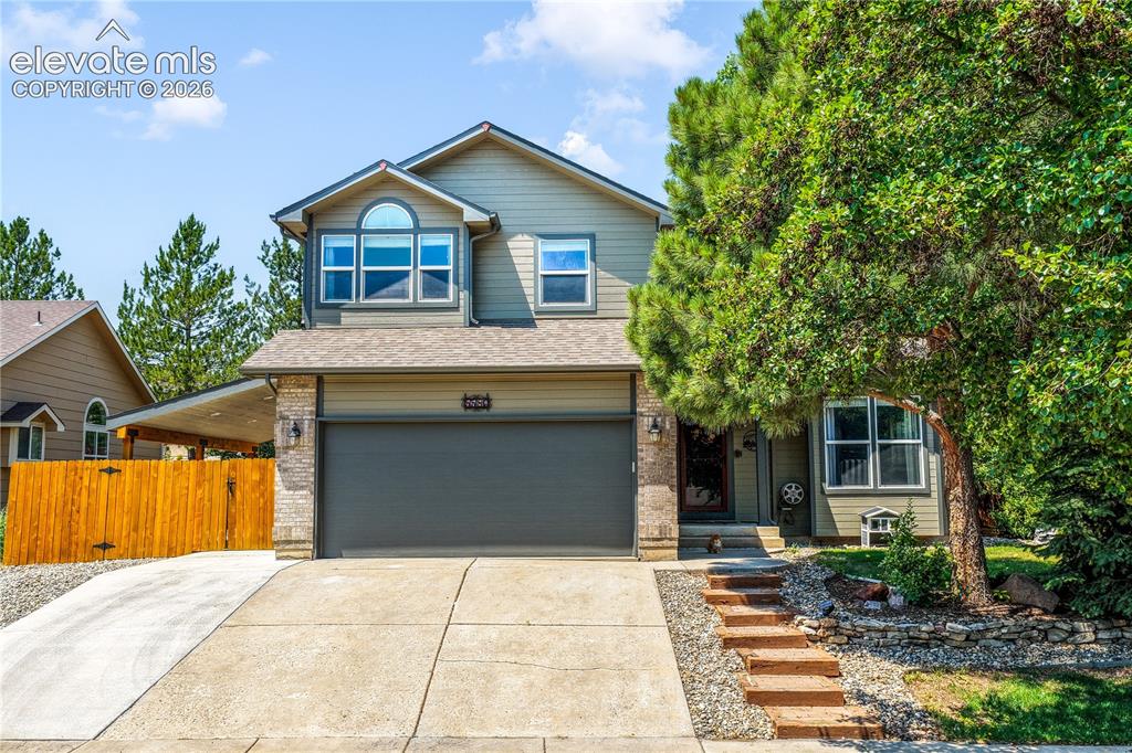 Image 6 of 50: Front of home, views of mountains, covered area on side of home