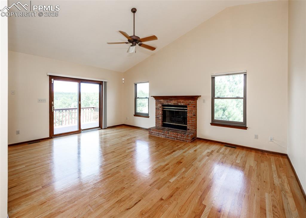Image 11 of 44: Large main level living room with fireplace