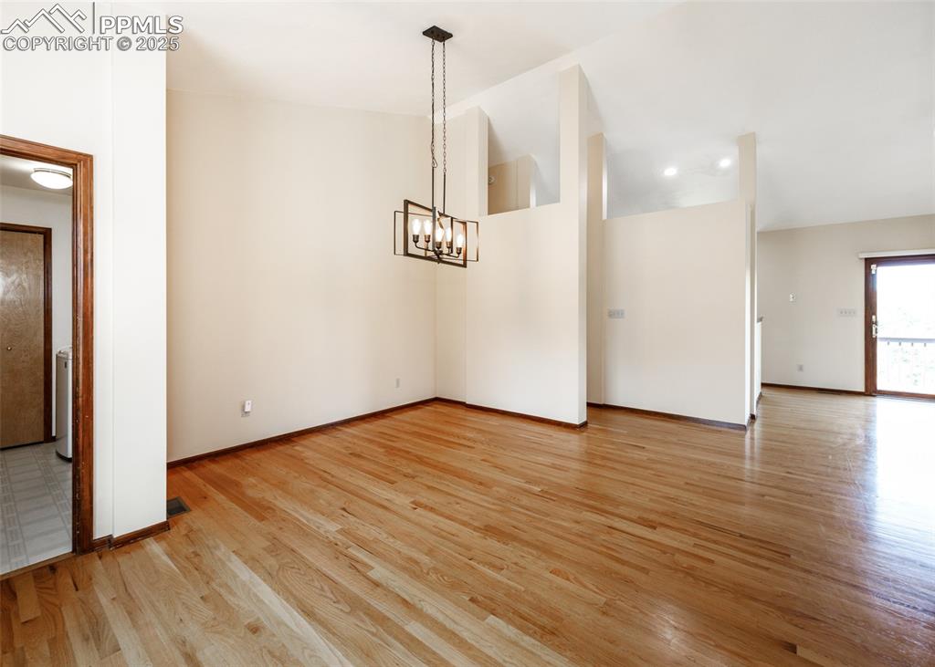 Image 13 of 44: Unfurnished dining area featuring light wood-style flooring, a chandelier, 