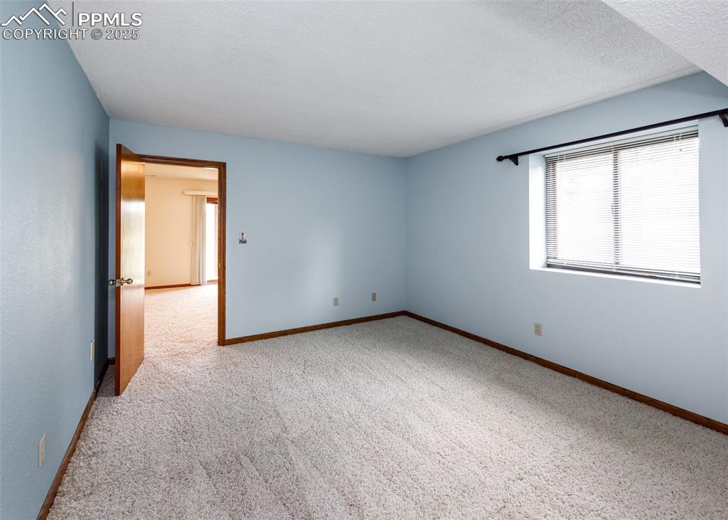 Image 29 of 44: Spare room with light carpet and a textured ceiling