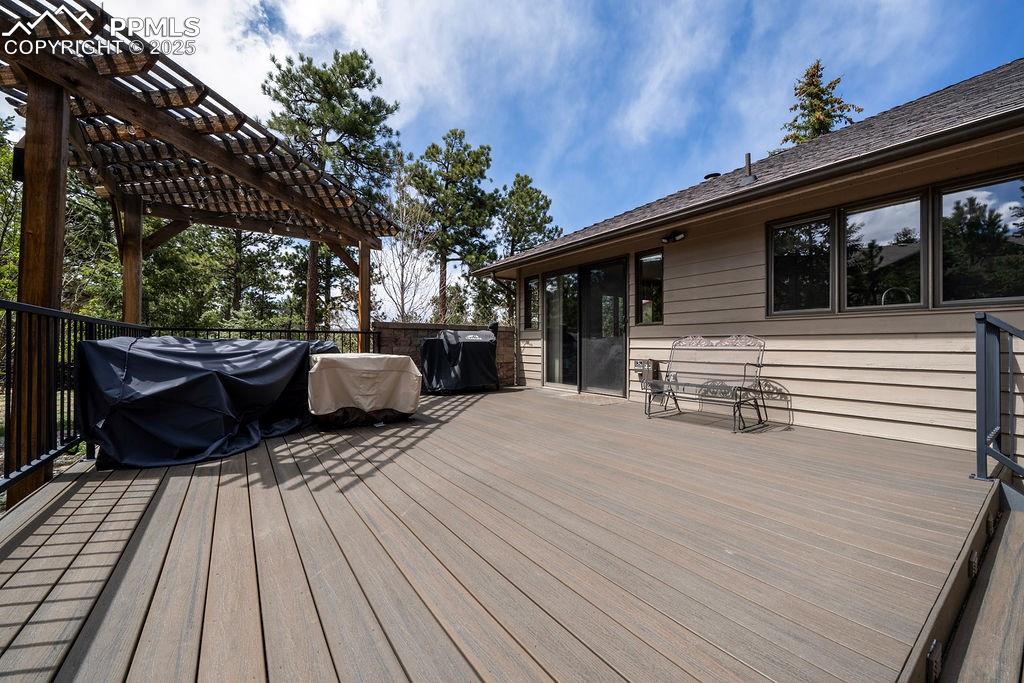 Image 33 of 42: Wooden deck with a pergola